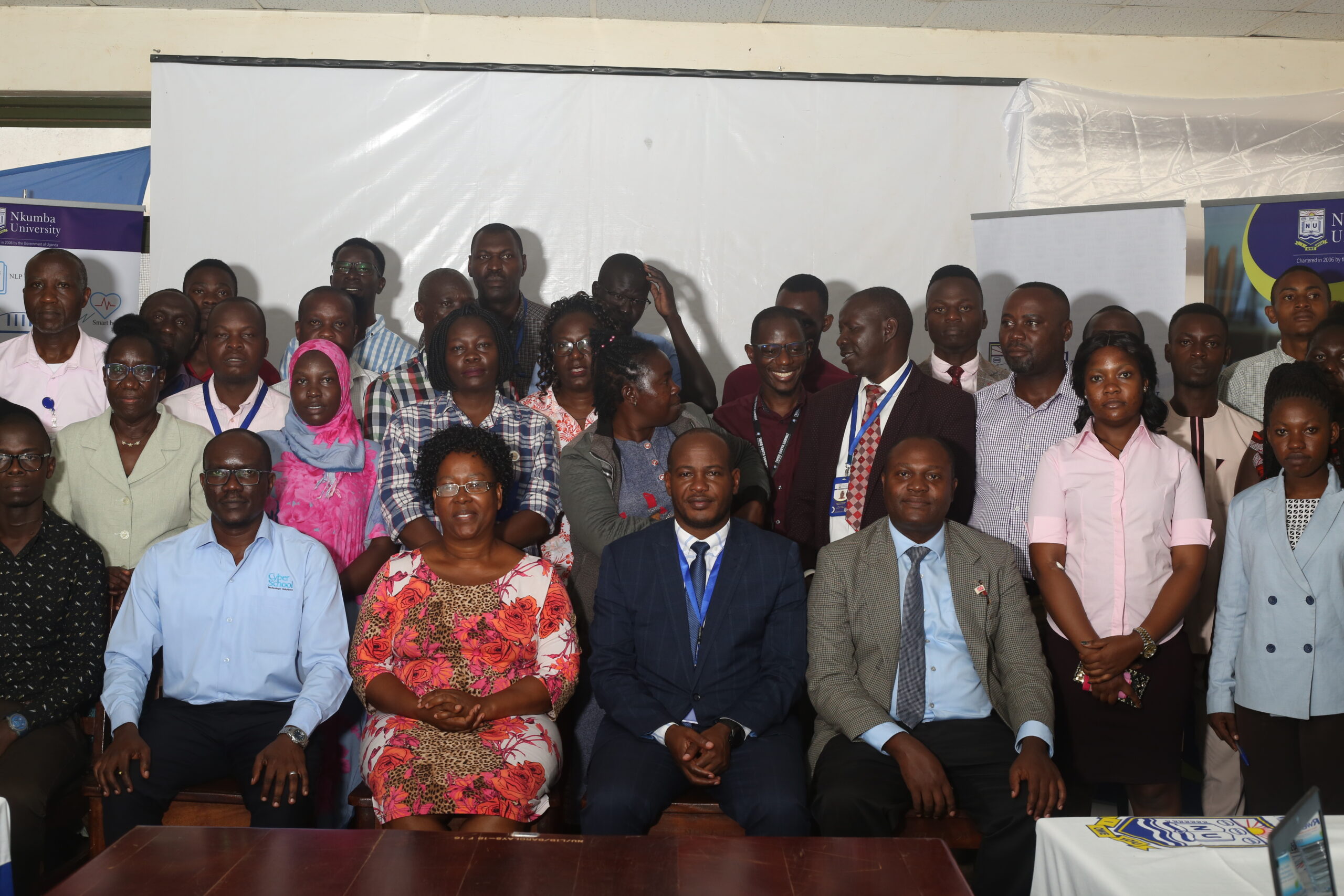 Management, staff and students pause for a photo after the meeting.