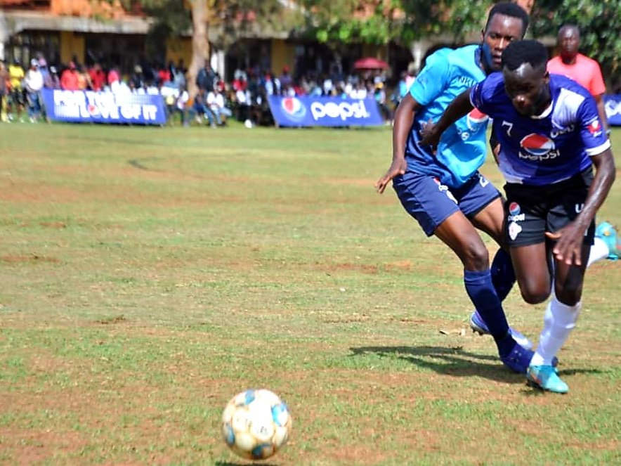 UCU striker dribbles past Nkumba defender//Japheth Godwin Walakira 