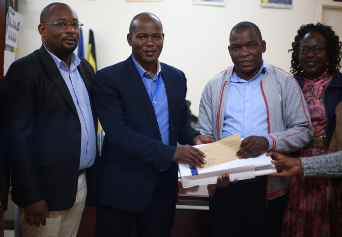 Prof. Jude Lubega (2nd L) joined by Dr. Byamukama (Far L) and Madam Viola (Far R) as they hand over the University's Annual Subscription fees to Mr. John Socrates Mugabi, The Chairperson, UNCCI -Entebbe Chapter.