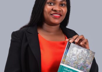 Dr. Susan Nakanwagi displays her book titled: Critical Minerals, Sustainability, and the Energy Transition in the Global South: A Justice Perspective.