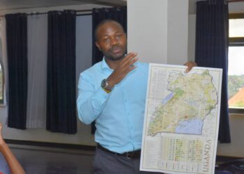 Julius Luwembe exploring Uganda's map during the training