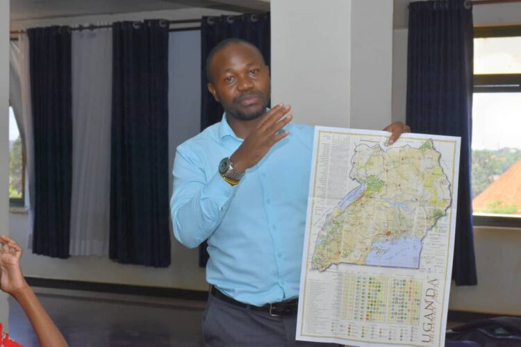 Julius Luwembe exploring Uganda's map during the training