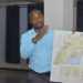 Julius Luwembe exploring Uganda's map during the training