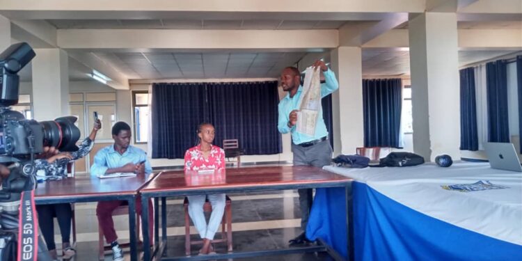 Luwemba while engaging students at the training.