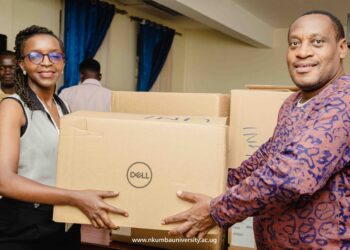 Adreen Kanyesigye (L) Handing Over the Consignment to Dr. Alex Barakagira (R)