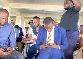 Offset stands up in protest just behind Former Guild Presidential Aspirant, Katended Mohammad