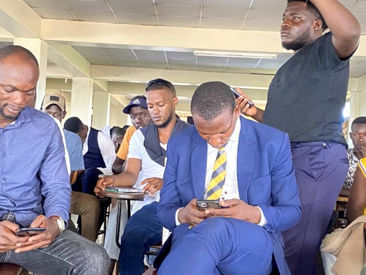 Offset stands up in protest just behind Former Guild Presidential Aspirant, Katended Mohammad