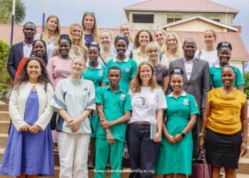 Nursing Students pose for a photo together with Vice Chancellor Prof. Jude Lubega in front of Mpanga Library