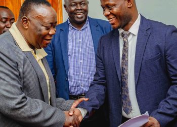 Secretary BOT, Dr. Ben Kintu Kamya (L), congratulating Dr. Bbosa (R)