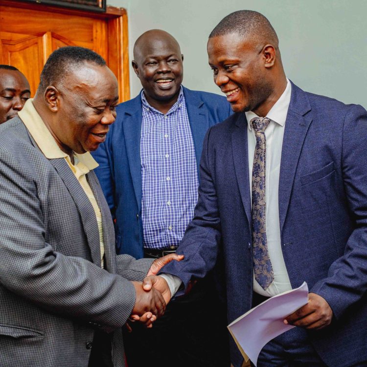 Secretary BOT, Dr. Ben Kintu Kamya (L), congratulating Dr. Bbosa (R)