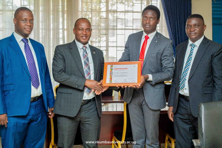 Debate Team Lead, Kagoda Peter (FR), delivering the Certificate of Participation to University Management; VC Prof. Jude Lubega (2ndL), DVC Dr. Sulaiman Bbosa (FL), and US Mr. Ssengendo Francis (FR)
